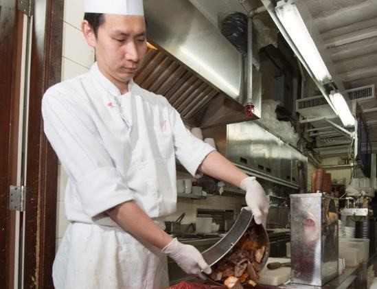 A staffer carries out food waste separation at a restaurant at the Hong Kong airport. Photo: Hong Kong International Airport © Hong Kong International Airport