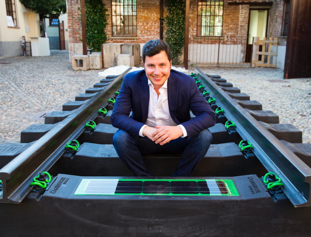Greenrail CEO and founder Giovanni De Lisi sitting on a prototype of the sleepers obtained with recycled plastic and tyre rubber - Credits: Greenrail